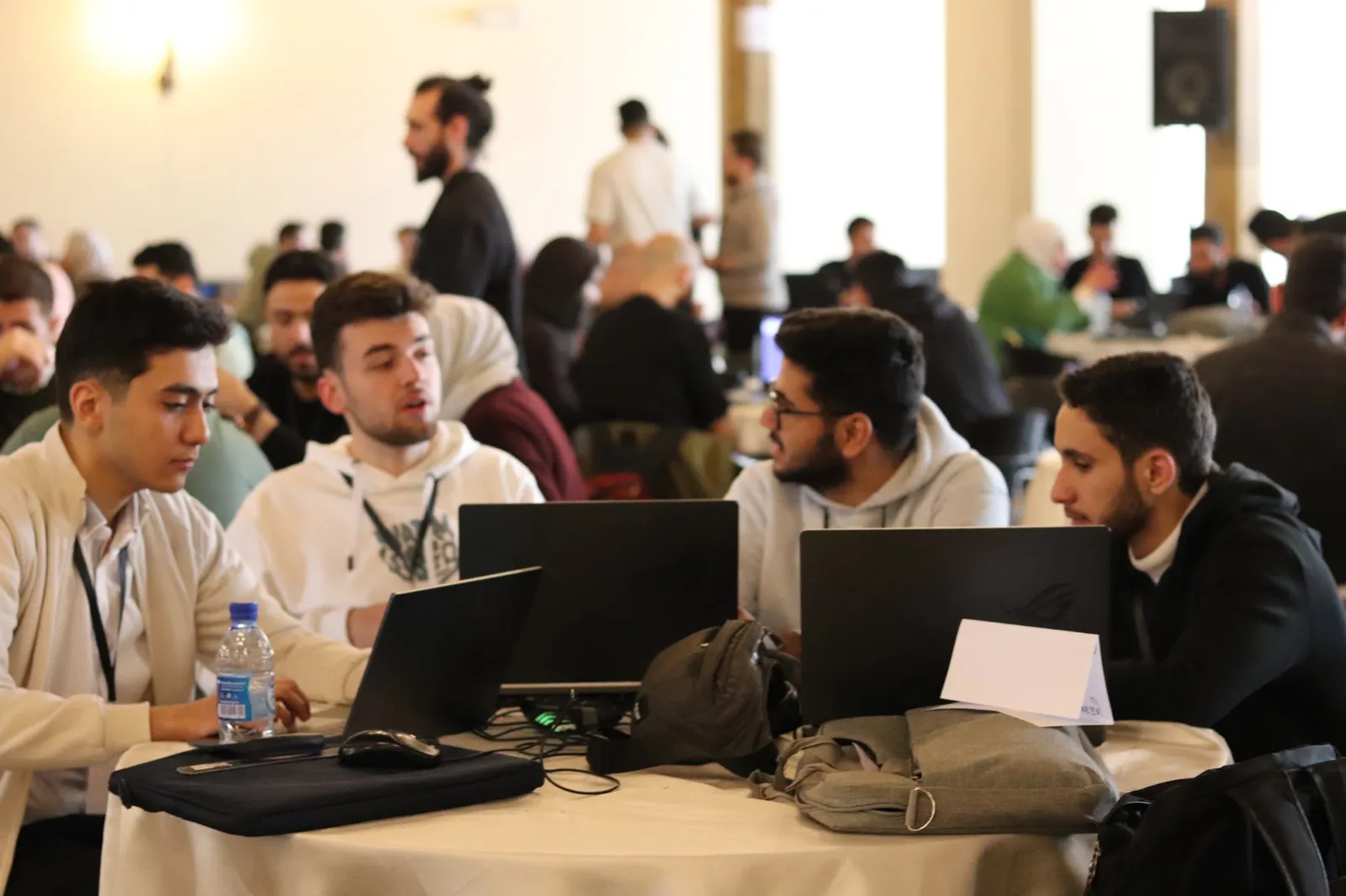 Four participants working around a table of laptops during Startup Weekend
